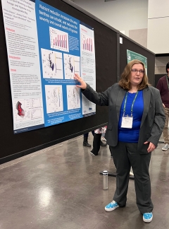 Allison Dreiss presents a scientific poster at a conference