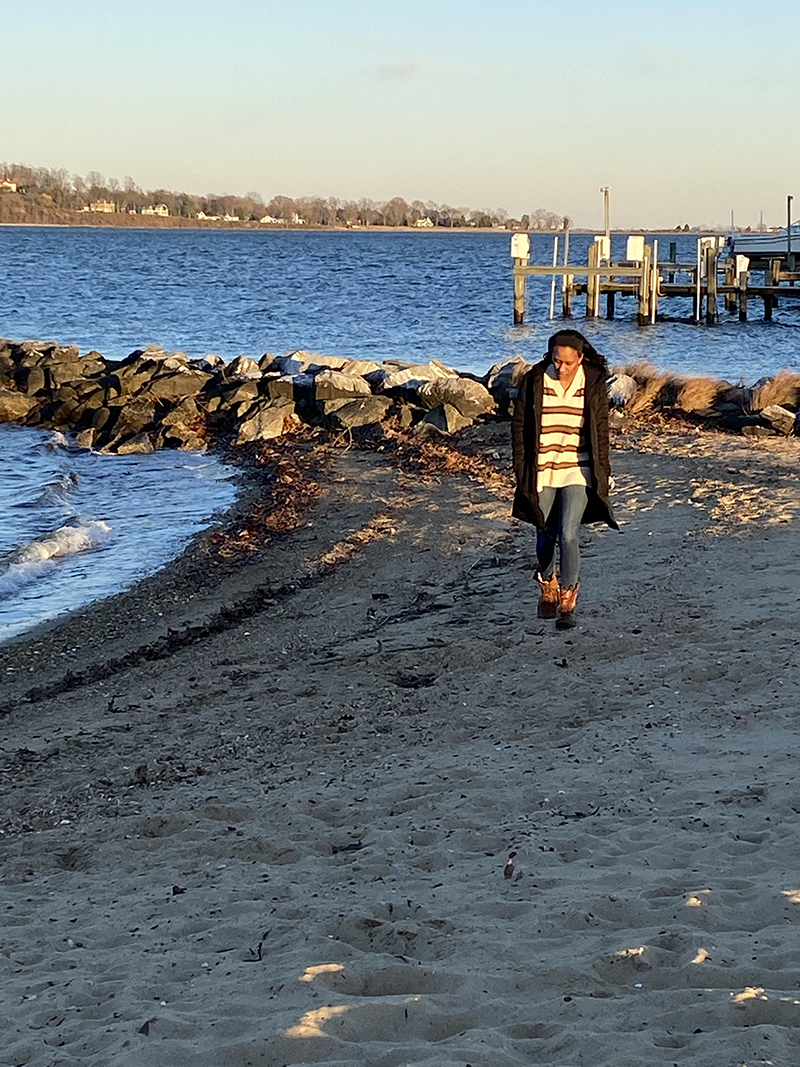 The author walking on a beach near her home.