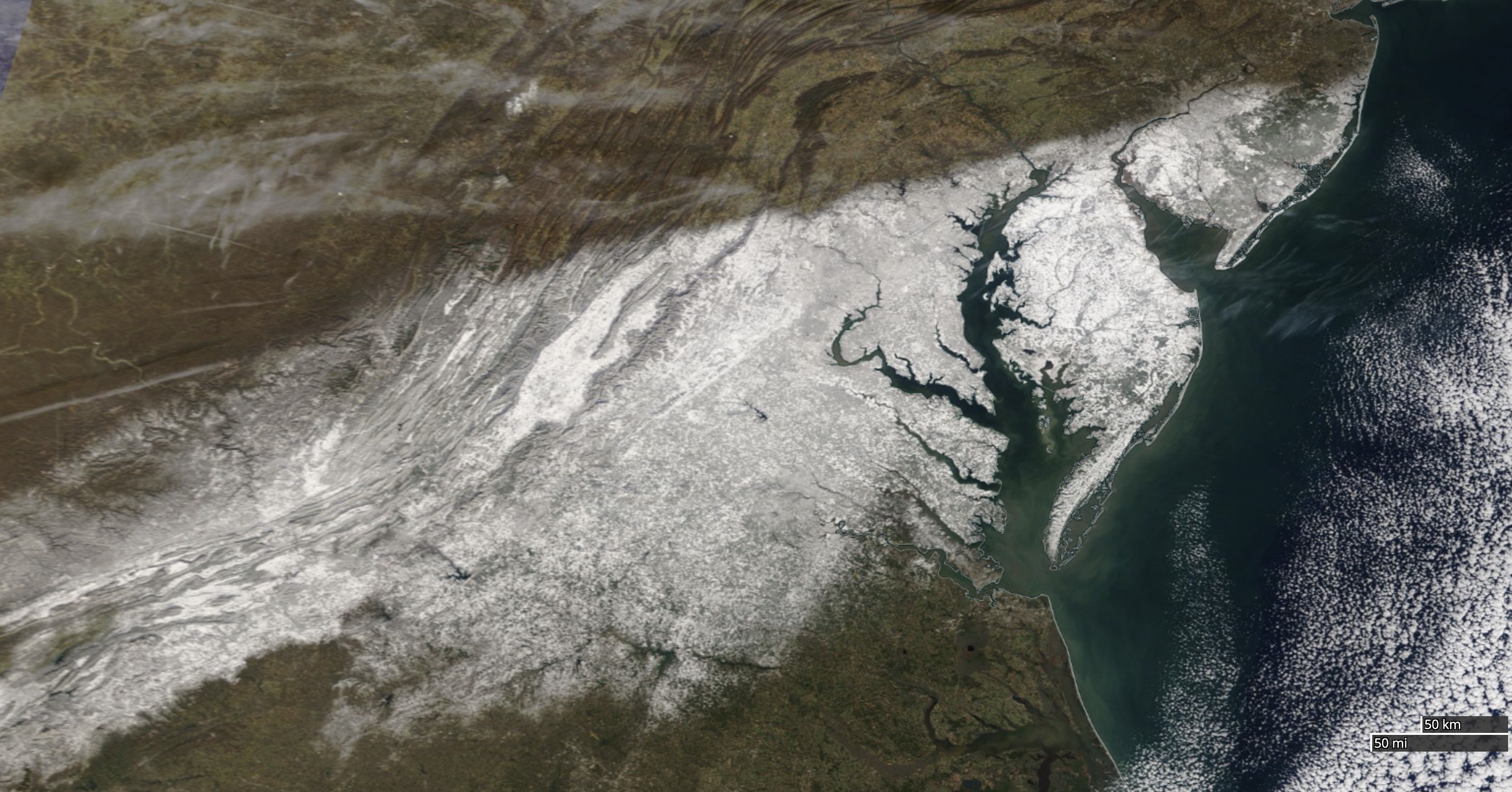 A view of the Chesapeake Bay nearly completely bordered by snow on January, 4, 2022. Photo Credit: NASA Earth Observing System Data and Information System