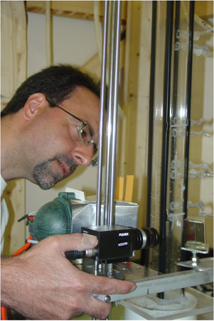 Mr. Schulman works with a video camera to film oyster larvae in a water column