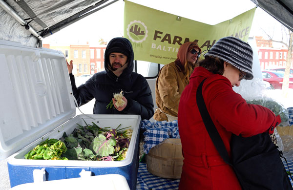 customers at a farmers market shopping for aquaponics greens