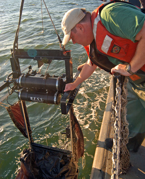 researcher pulling the high tech net onto the research vessel