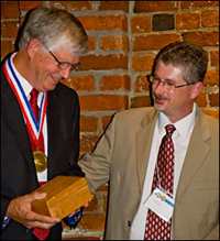 eugene burreson receives medal from troy hartley