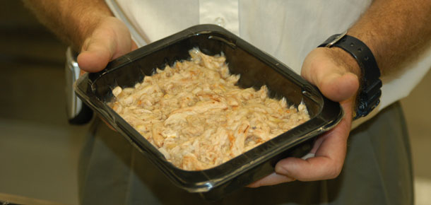 person holding tray of fresh crab meat