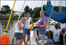 reu students relaxing aboard a sailboat