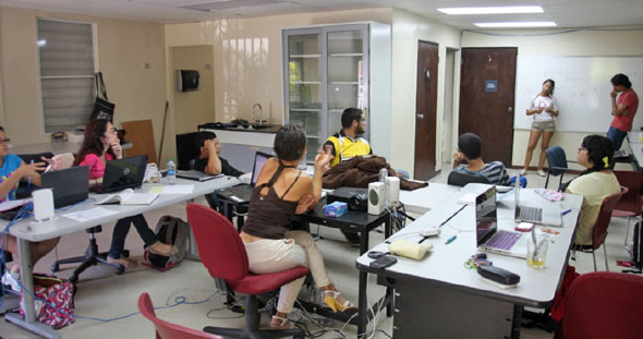 students at tables watching presentations