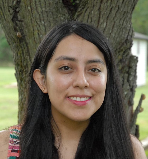 Portrait of Paulina Huanca-Valenzuela standing in front of a tree