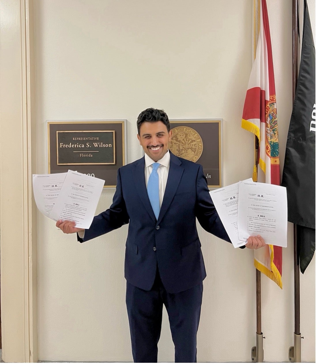 Abdulmajid Alrefaie outside Congresswomen Wilson’s office, holding the four bills he helped manage and introduce during his Knauss Policy Fellowship year. 
