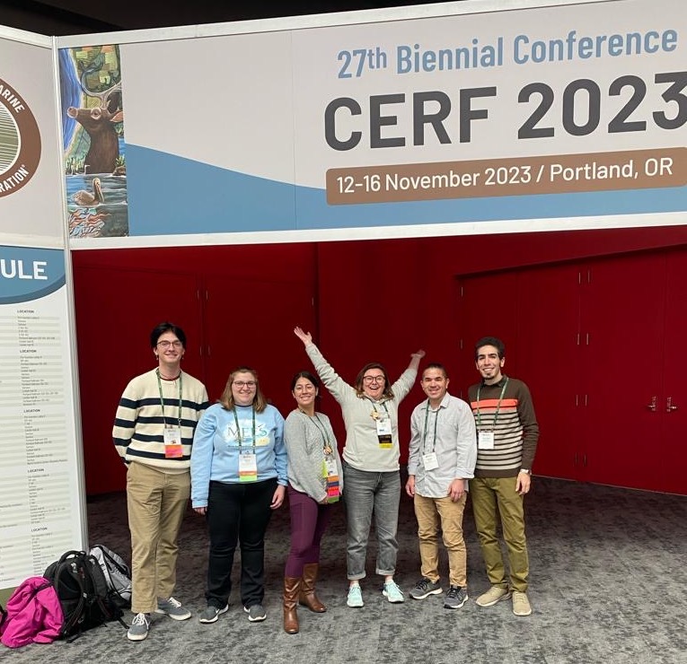 A group of students pose at a conference under the "CERF 2023" sign