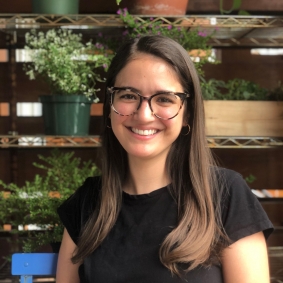 Portrait of Aliya Mejias in front of potted plants