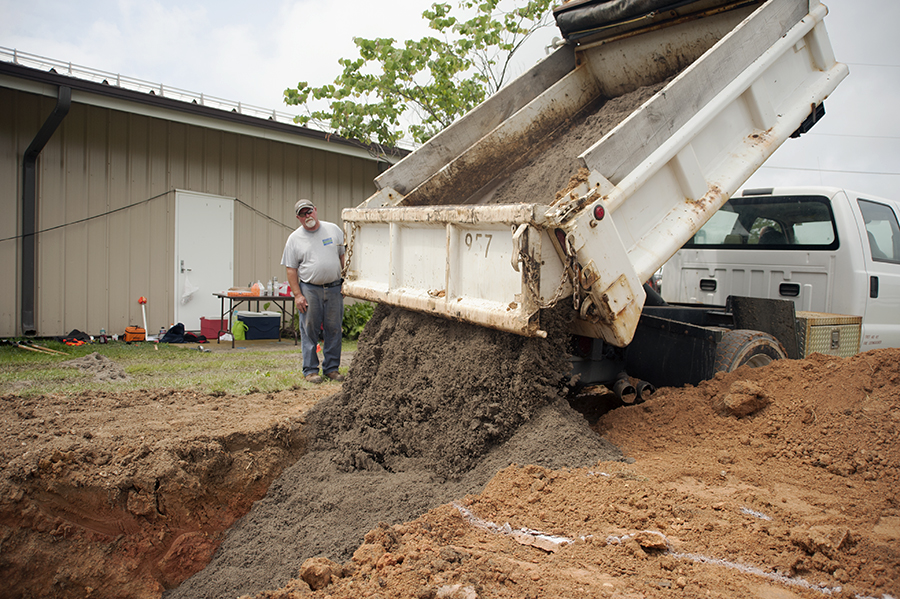 The hole was filled with biosoil — a special mix of sand and organic matter. Biosoil binds pollutants, provides a medium for the garden’s plants to take root, and allows excess stormwater to percolate down into the sandy layer beneath the garden. Photo: Daniel Pendick  