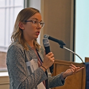 Picture of Eva May reporting out on her group’s ideas on sea level rise impacts at the close of the roundtable meeting.