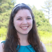 Image of Suzi Webster, smiling with a blue shirt and long hair