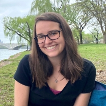 Headshot of Carly Maas near water.