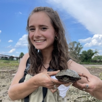 Sabine Malik holds a turtle.