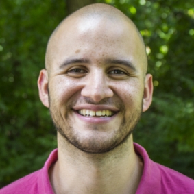 Smiling man in a pink shirt