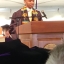 Kai Hardy stands behind a podium wearing a cap and gown and gives a speech during a Vermont Law School graduation ceremony