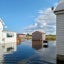 A house and shed are surrounded with floodwaters up to their foundations in Tylerton on Smith Island