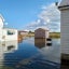 A house and shed are surrounded with floodwaters up to their foundations in Tylerton on Smith Island
