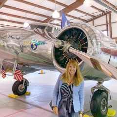 Melanie Jackson standing in front of Muriel, one of only 14 Lockheed Electra L-10E airplanes ever made—in 1935—and the last surviving one.