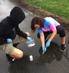 high school students display water samples taken in their schoolyard