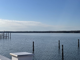 Dock pilings extend from the surface of the Patuxent River on a cloudless day.