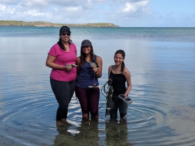 (L to R) Patricia N. Vidal Geraldino, Shakira Gómez Arias, and Génesis López Santana take a moment for a photo in Laguna Grande during the 2018 TORTUGA workshop. Credit: Mike Allen / MDSG