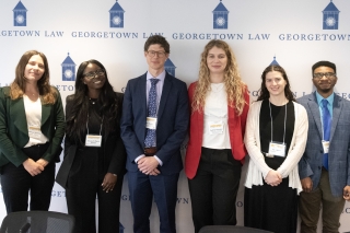 A group of law students pose together during a symposium