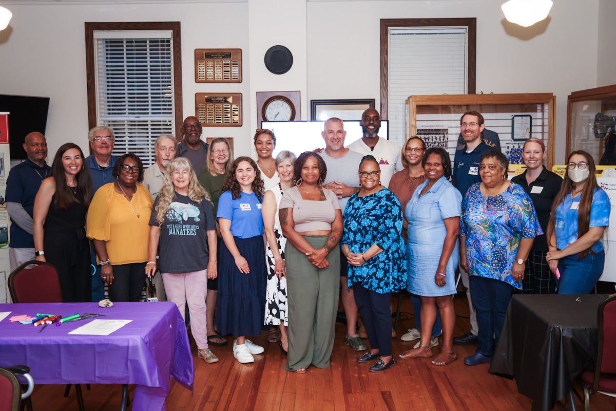 A group of Galesville, MD, residents and Maryland Sea Grant Staff pose together inside a community center