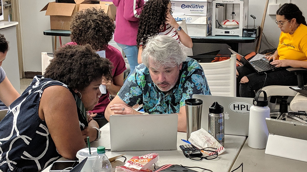 James Pierson, program co-director and principal investigator from the University of Maryland Center for Environmental Science Horn Point Laboratory, examines data with TORTUGA student Yaidelisse A. Rivas Rivera during a workshop in Puerto Rico. Credit: Mike Allen / MDSG