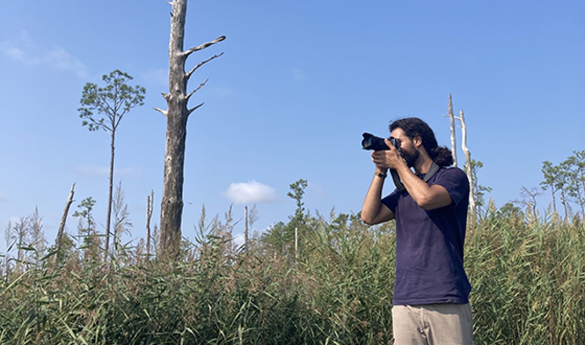 Yazan capturing a photo in a ghost forest